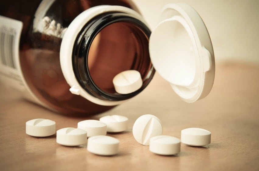 Glass prescription bottle with pills