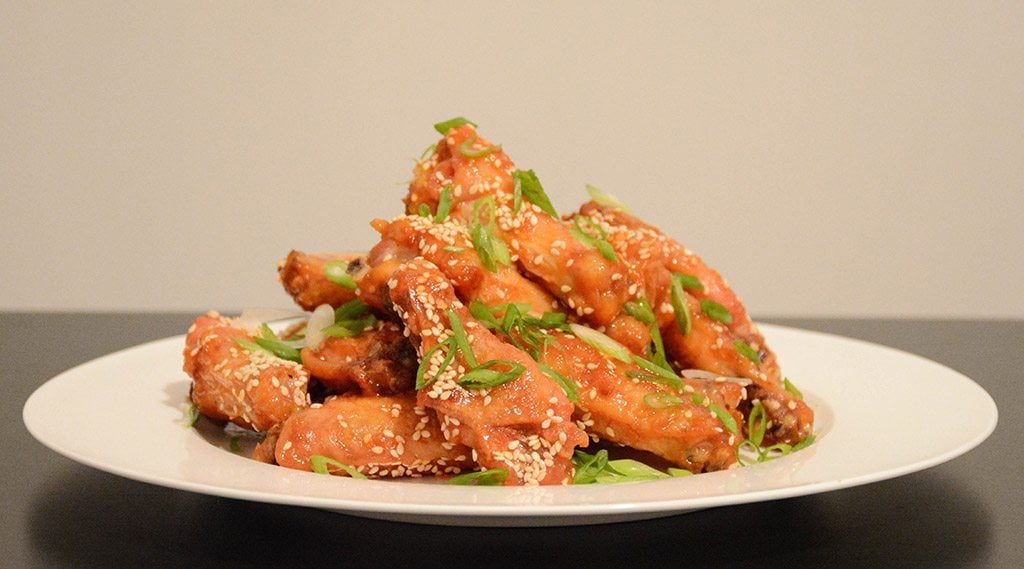profile of a plate of orange-sesame chicken wings