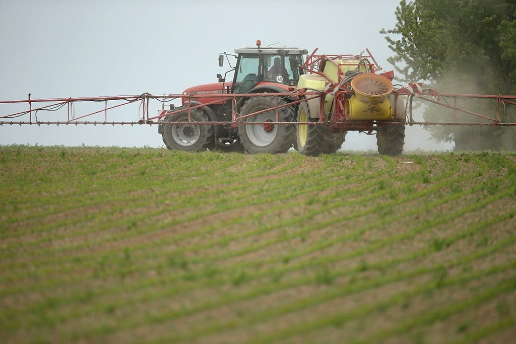spraying pesticides on crops