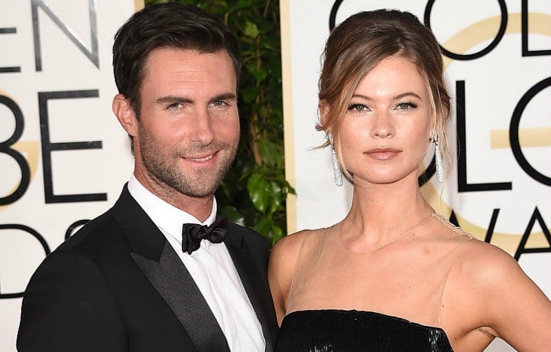 Adam Levine and Behati Prinsloo pose together on the red carpet of the Golden Globe Awards.