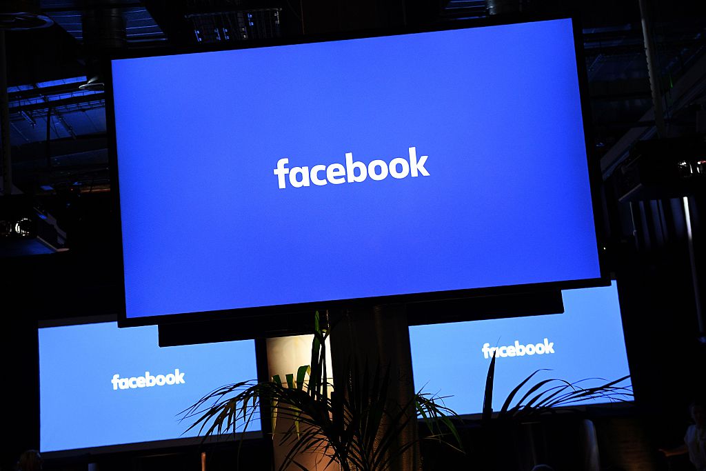 A Facebook logo is pictured on a screen ahead of a press conference to announce the launch of it's latest product "Workplace"