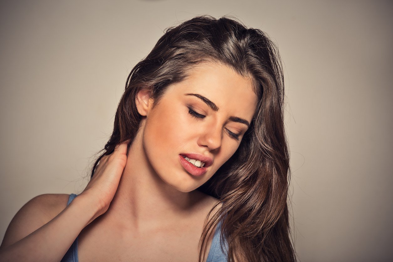 woman massaging her painful neck