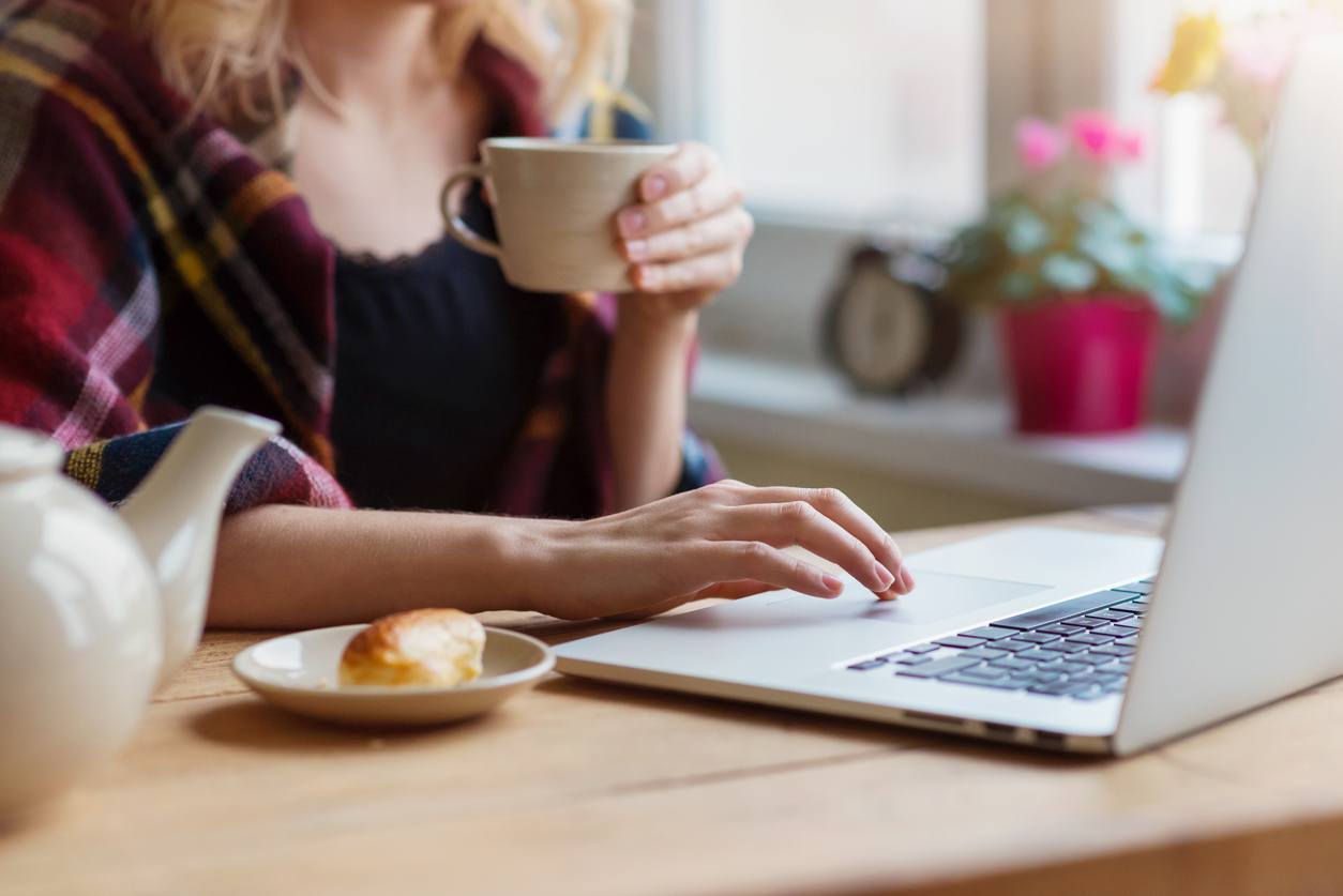 Beautiful woman relaxing at home with notebook
