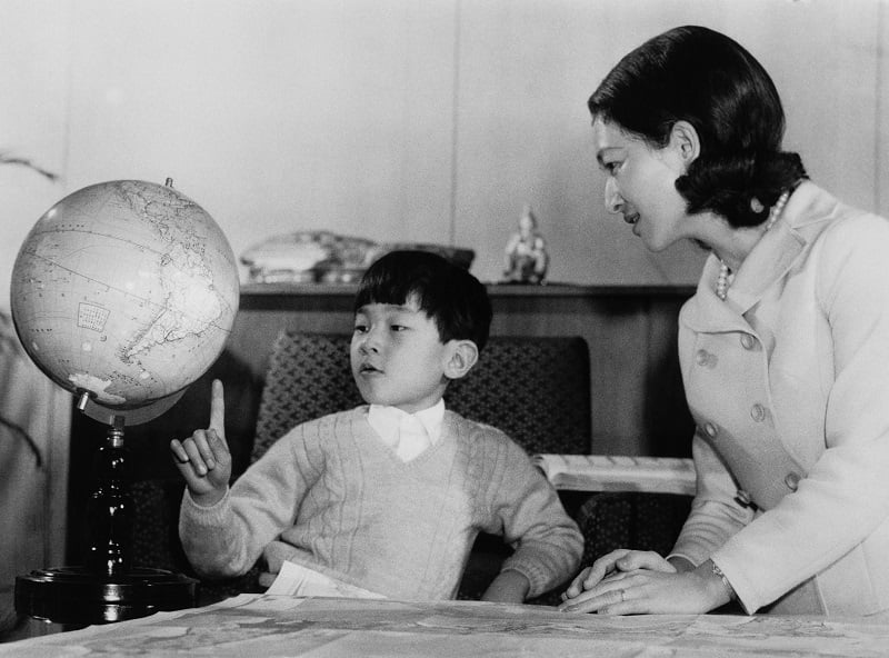 A young Prince Hiro, aka Crown Prince Naruhito of Japan, studying a globe with his mother and pointing out future hot spots for job seekers