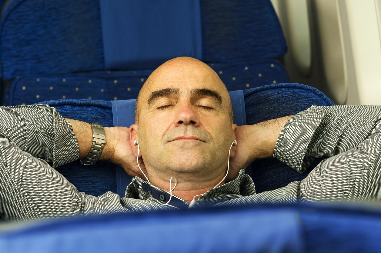 man in airplane sleeping