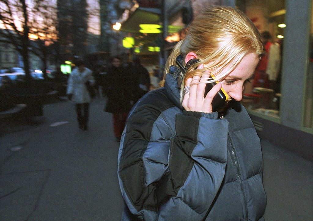 A teenage girl talks on her GSM mobile phone January 26, 2001 in central Prague, Czech Republic