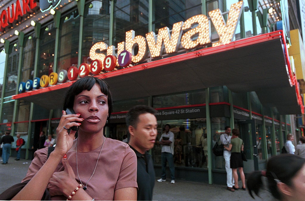A woman speaks on a cellular phone in Times Square July 17, 2000 in New York