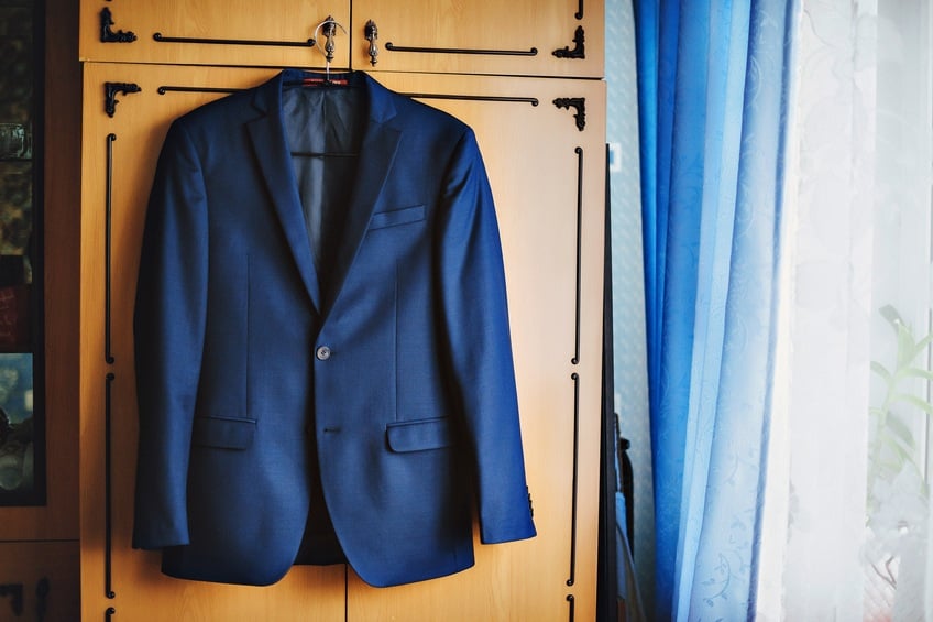 blue suit jacket on a hanger