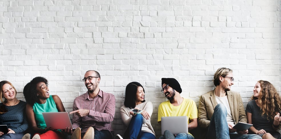 A group of coworkers share a hearty giggle
