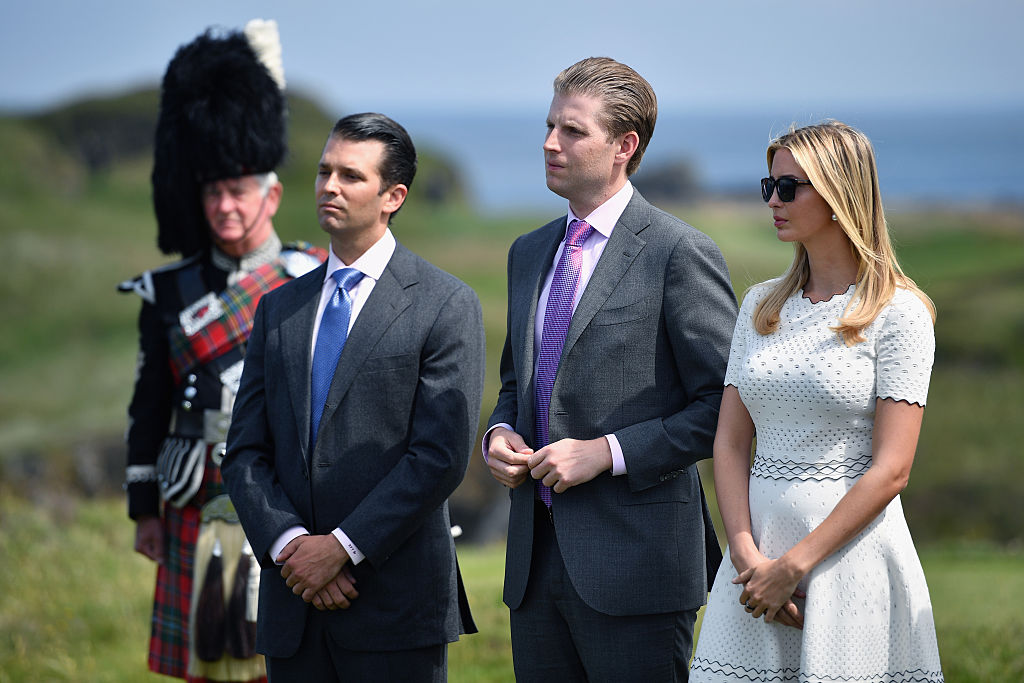 Donald Trump junior, Eric Trump and Ivanka Trump listen to their father