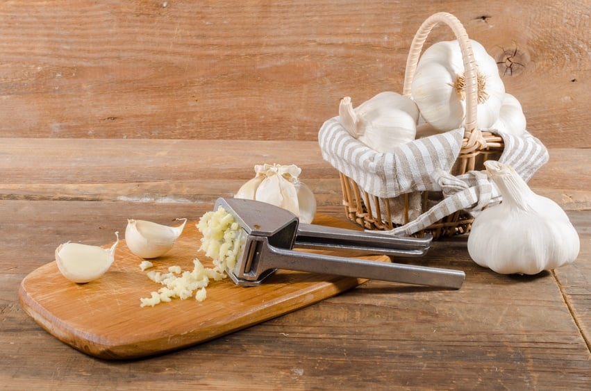crushed garlic on wooden background