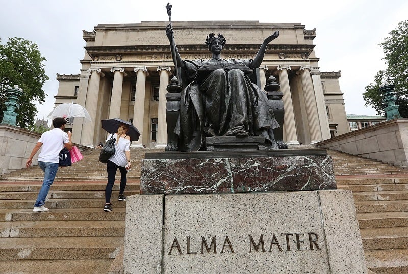 Students walk past the Alma Mater statue on the Columbia University campus, trying not to think about their hefty student loans