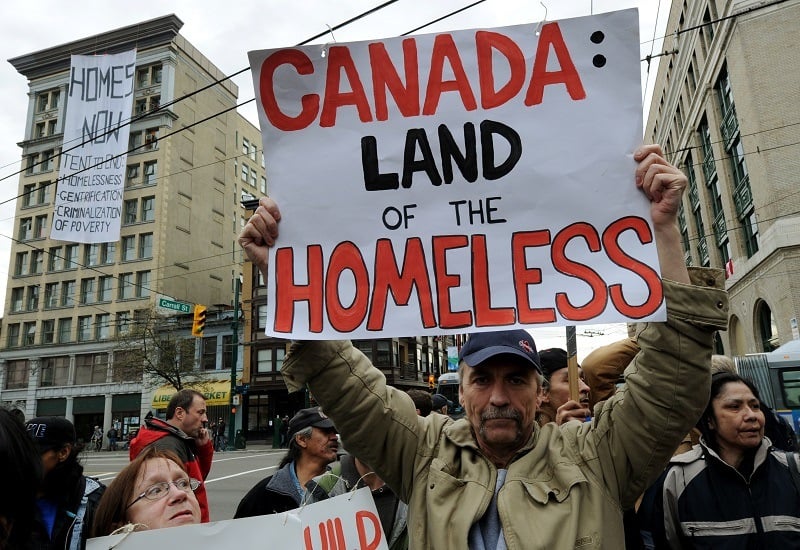 A man protests against homelessness near the Olympic Tent Village during the 2010 Winter Olympics