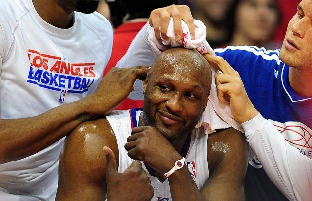 Lamar Odom sits on a stand at a basketball game while being wiped down. Lamar Odom sits on a stand at a basketball game while being wiped down.