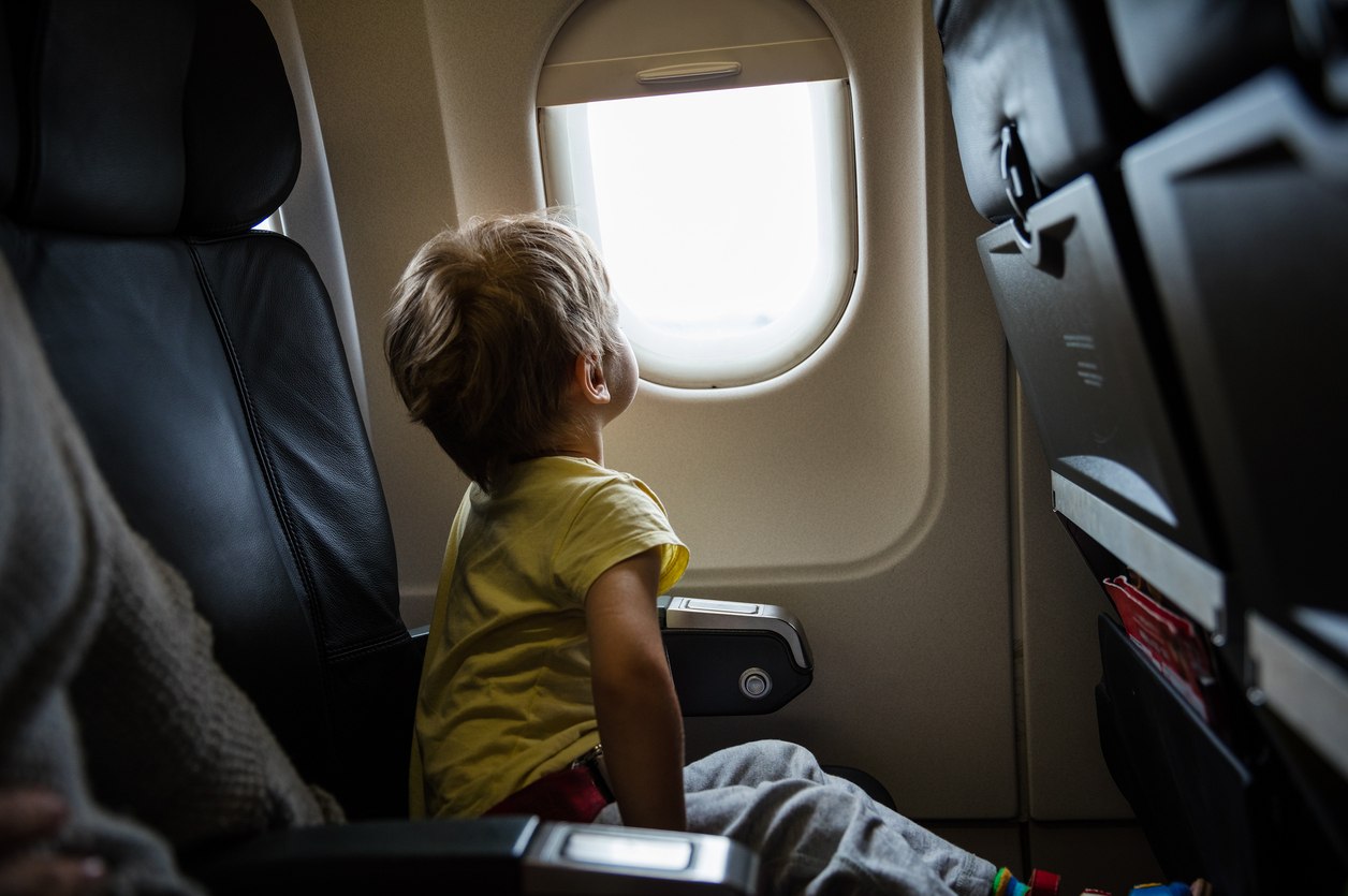 Little boy looking out of window