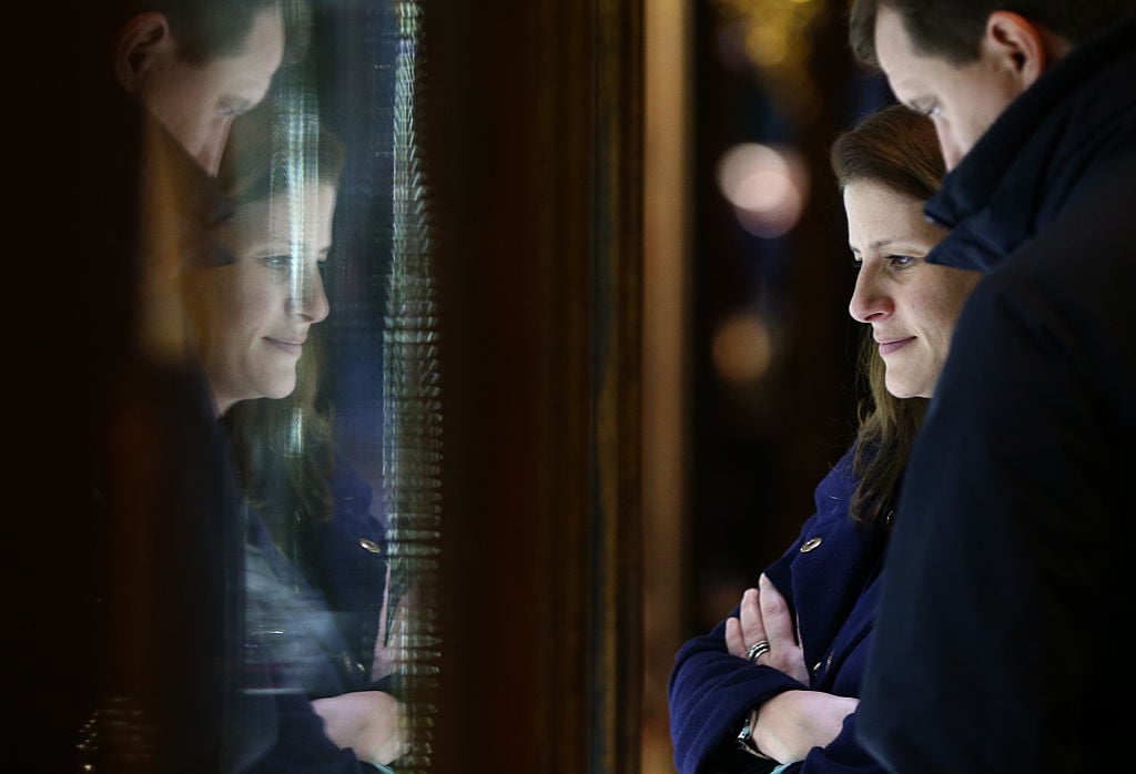 A couple look in the window of a store in a luxury shopping arcade