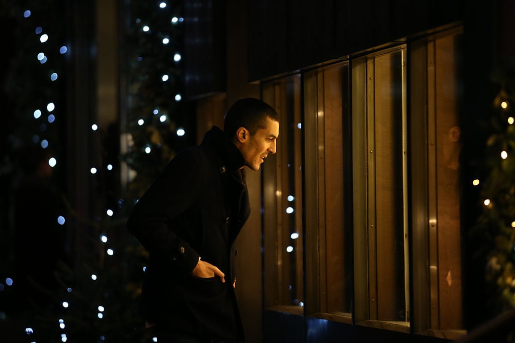 A man looks into the window of an antique jewellery shop