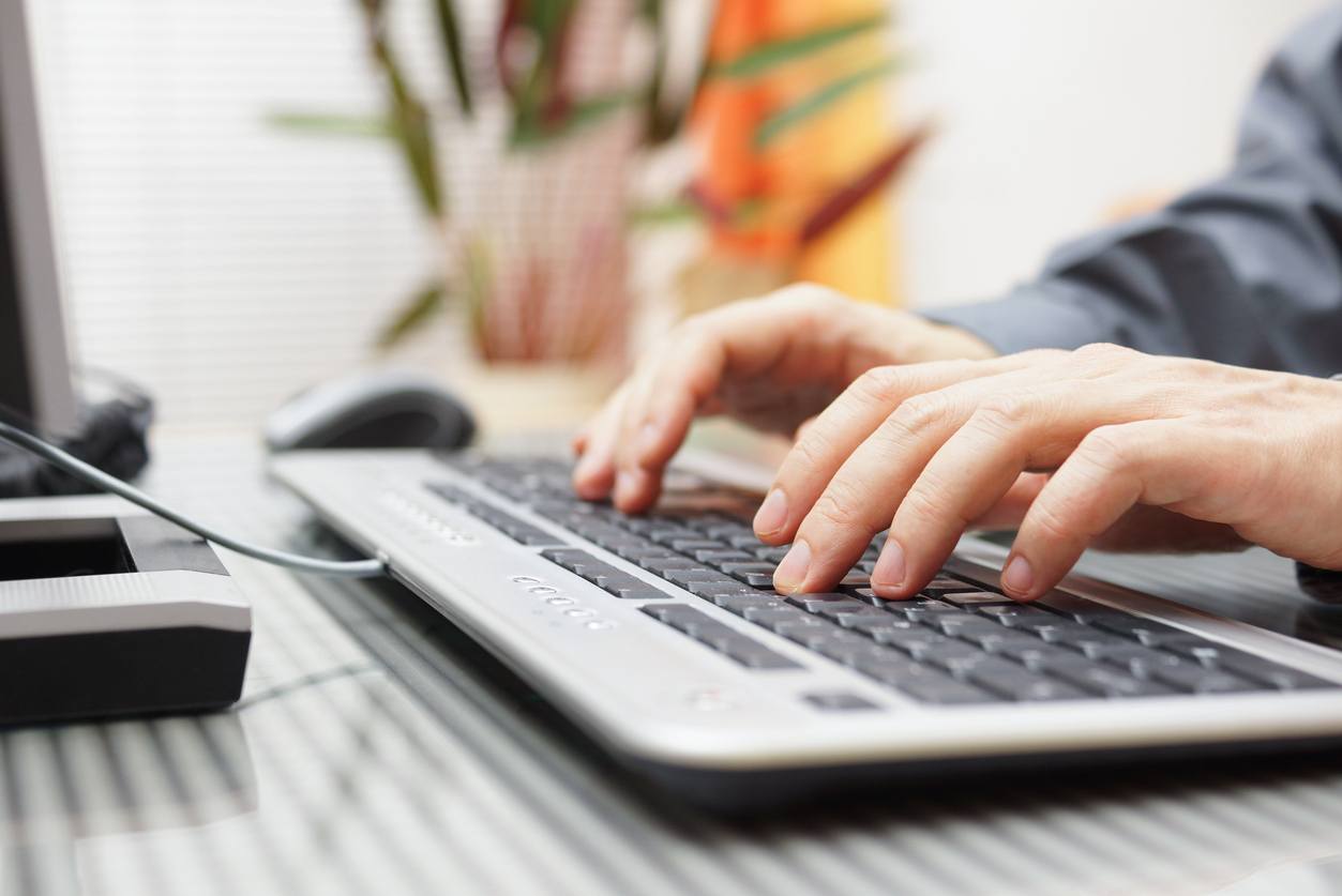 man is typing on keyboard