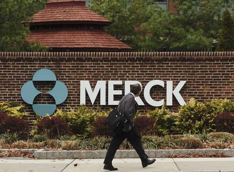 RAHWAY, NJ - NOVEMBER 29: A man walks by a sign at a Merck plant November 29, 2005 in Rahway, New Jersey. U.S. pharmaceutical giant Merck, announced plans to cut some 7,000 jobs, or 11 percent of its global workforce, by the end of 2008. 