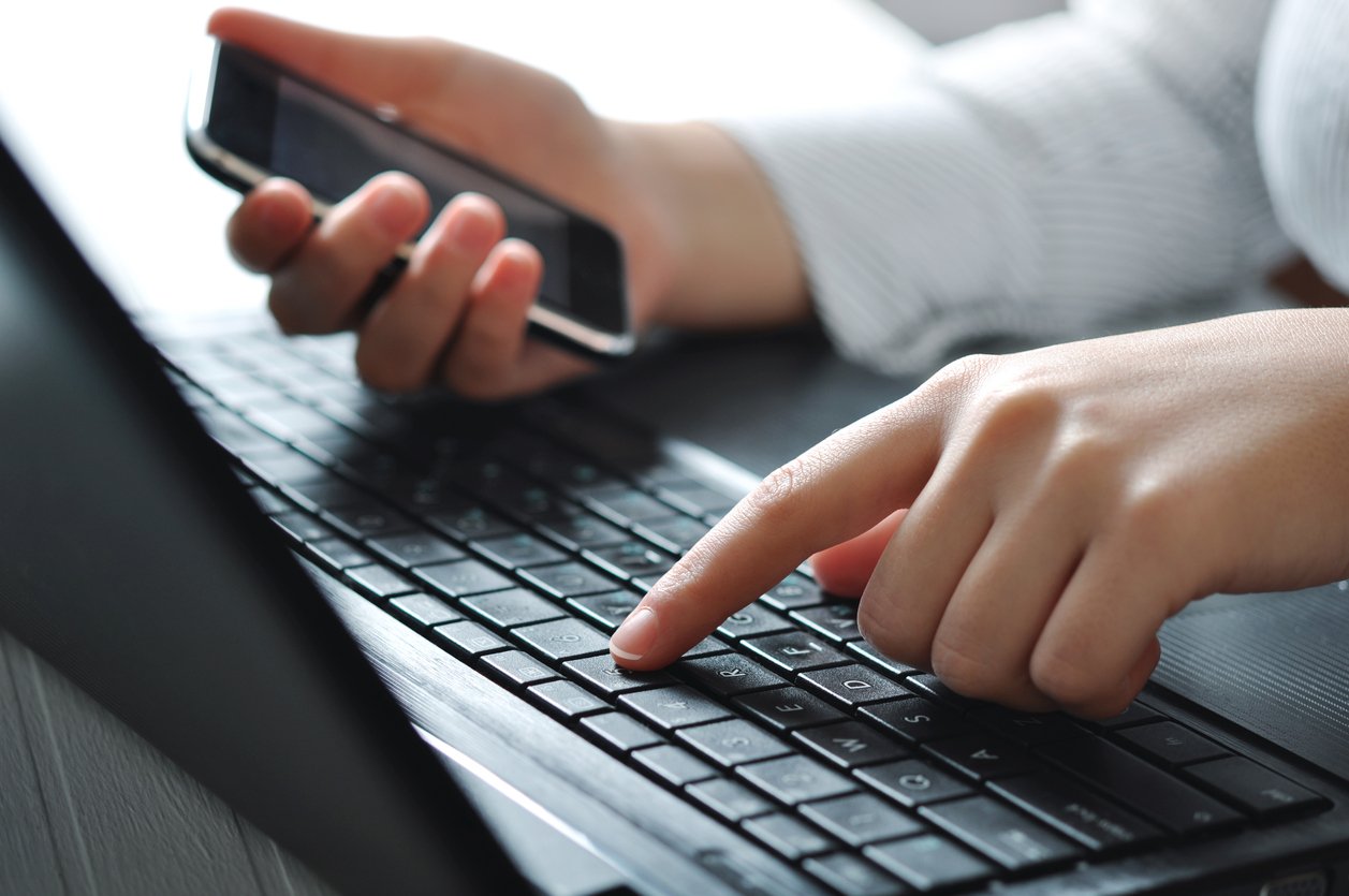 Female hands using laptop keyboard