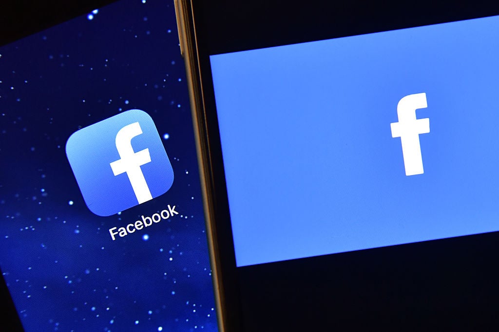 The Facebook app logo is displayed on an iPad next to a picture of the Facebook logo on an iPhone