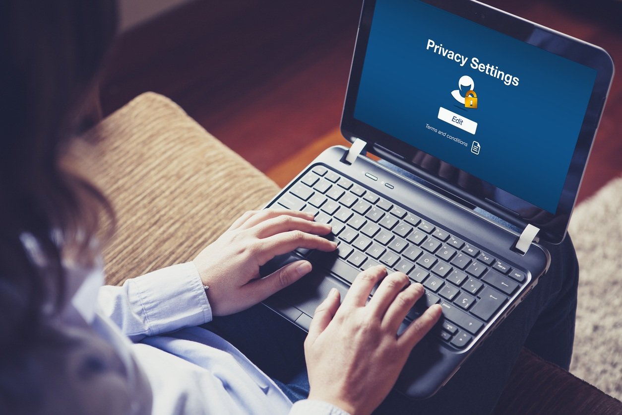 Woman using Privacy Settings on laptop