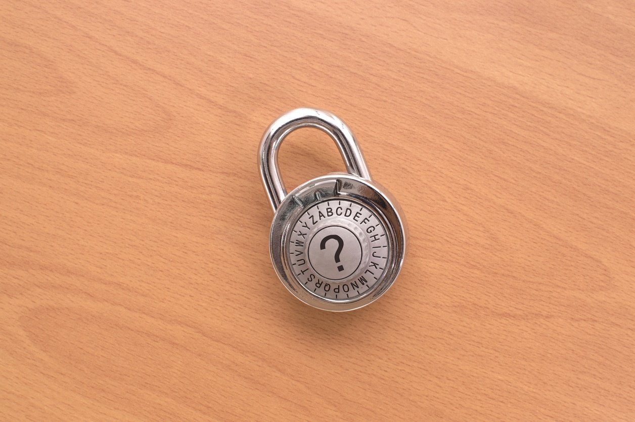 Question Mark Combination Lock on wooden background