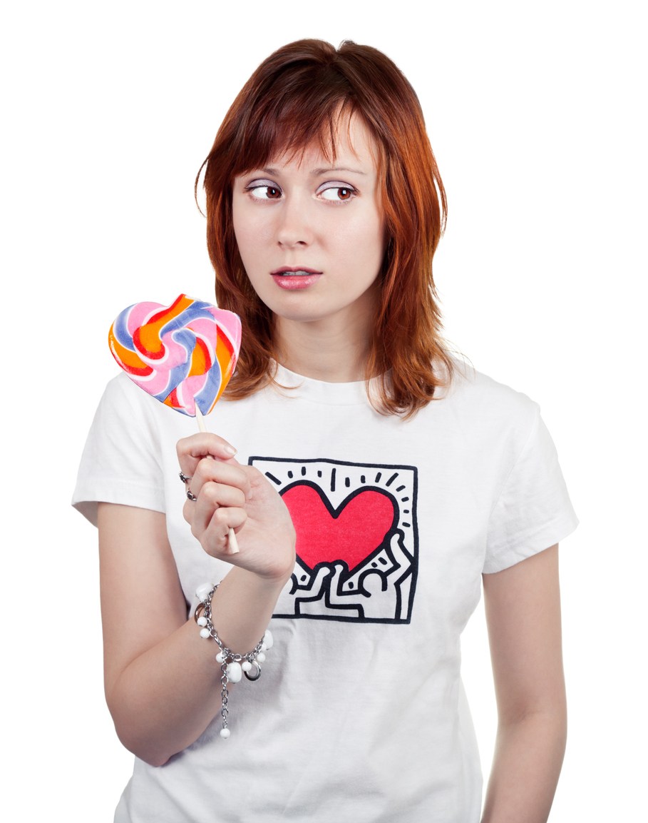 red-haired young woman with a colorful candy