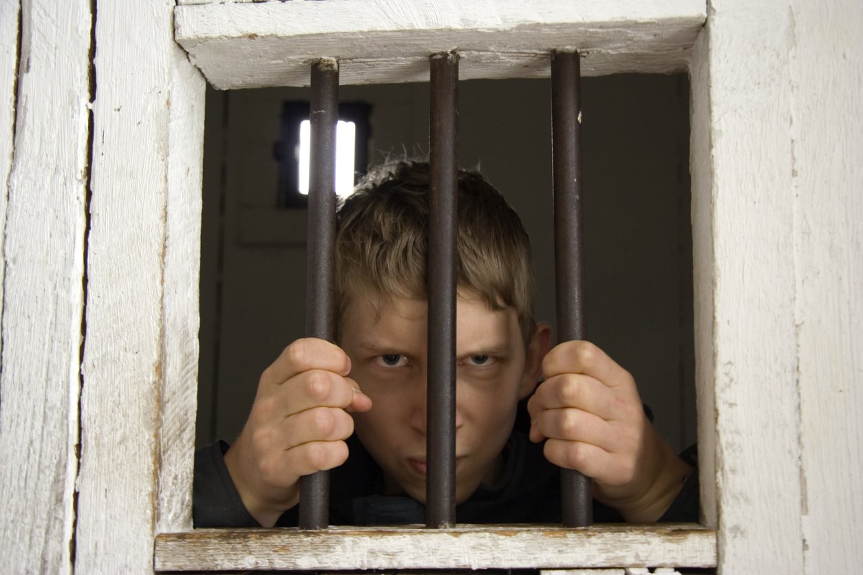 man behind prison bars