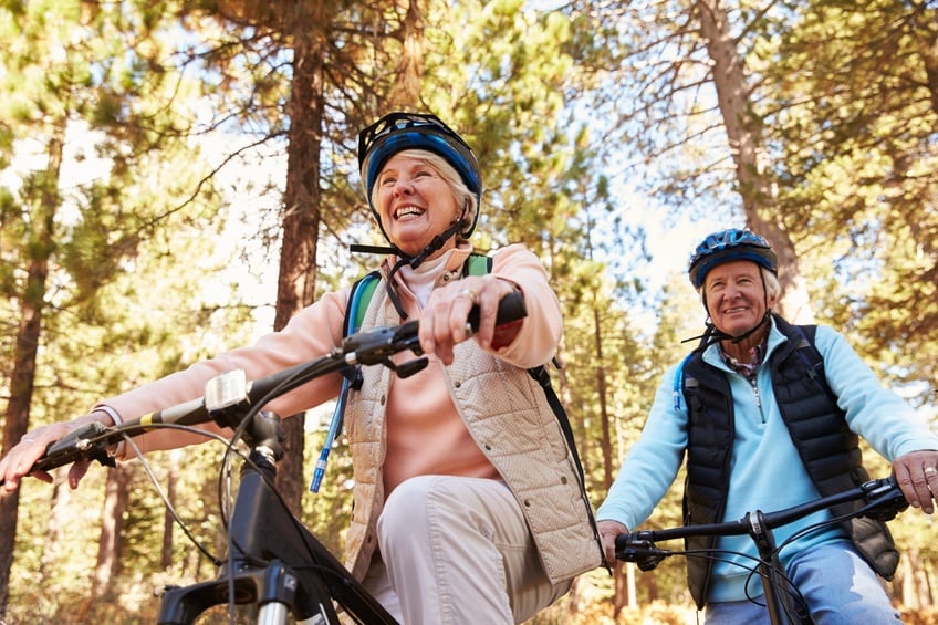 Senior couple mountain biking
