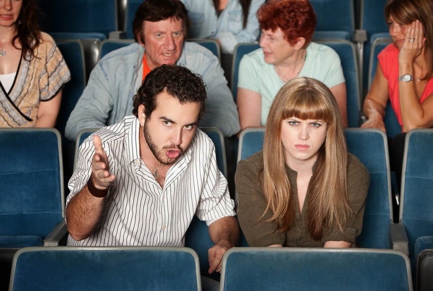 unhappy couple in a movie theater