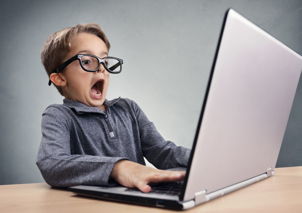 surprised boy on a computer