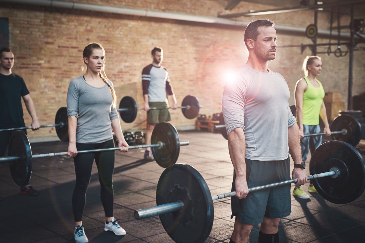 Serious muscular bearded man in shorts and gray tee shirt