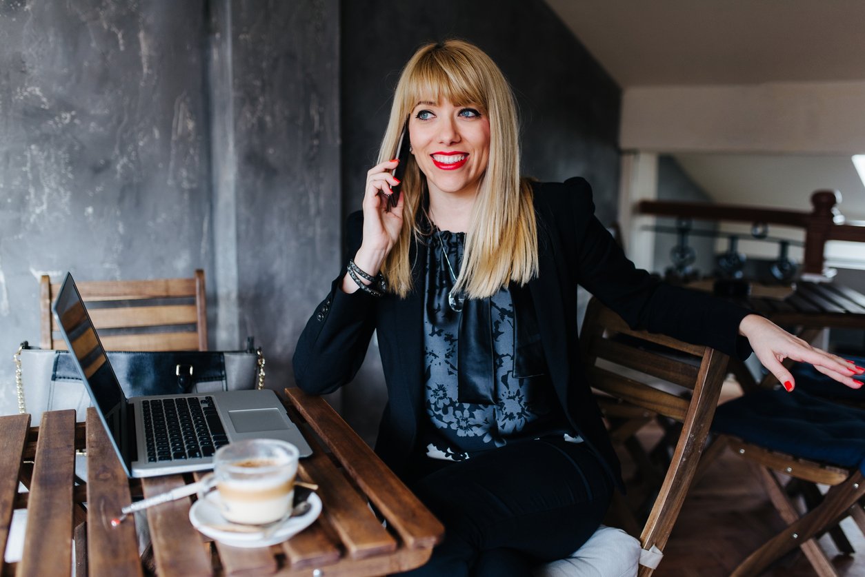 Smiling with curiosity and sincerity while having a phone call
