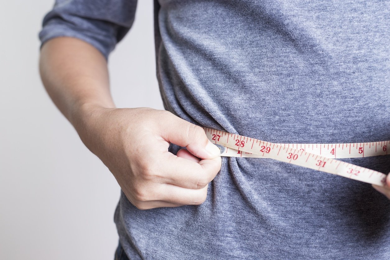 Woman checking her waistline