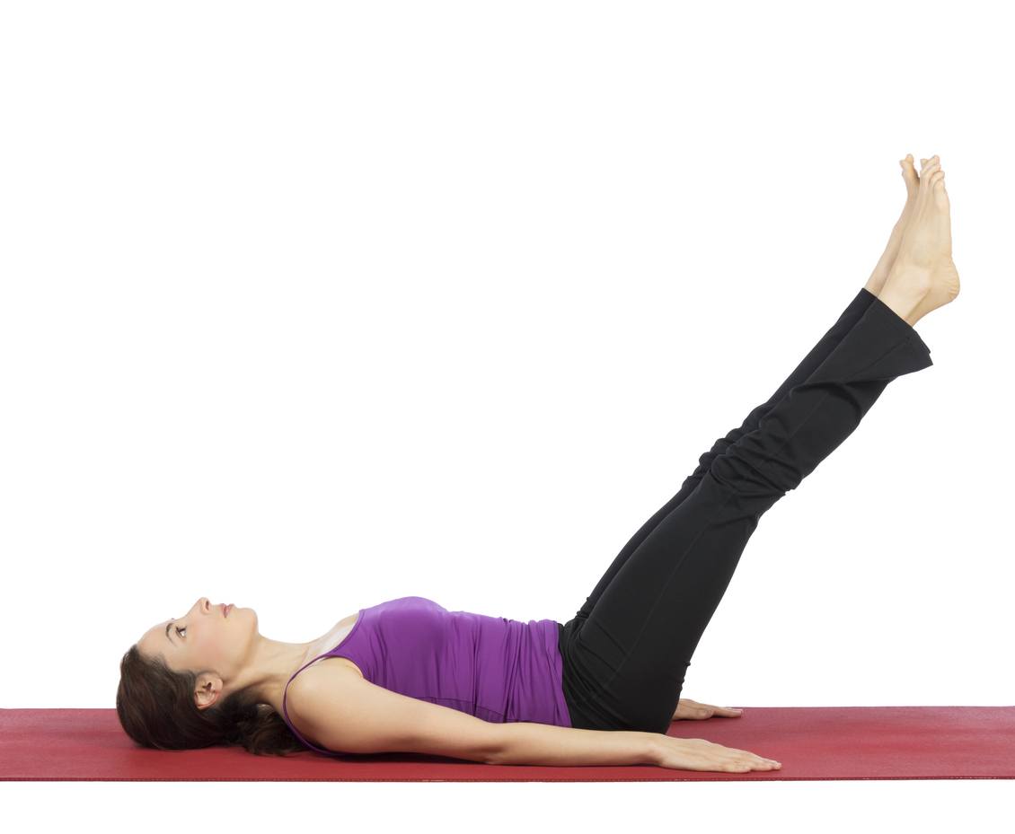 woman is working out her legs and abs