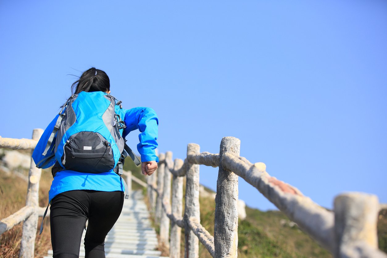 woman climbing mountain staris