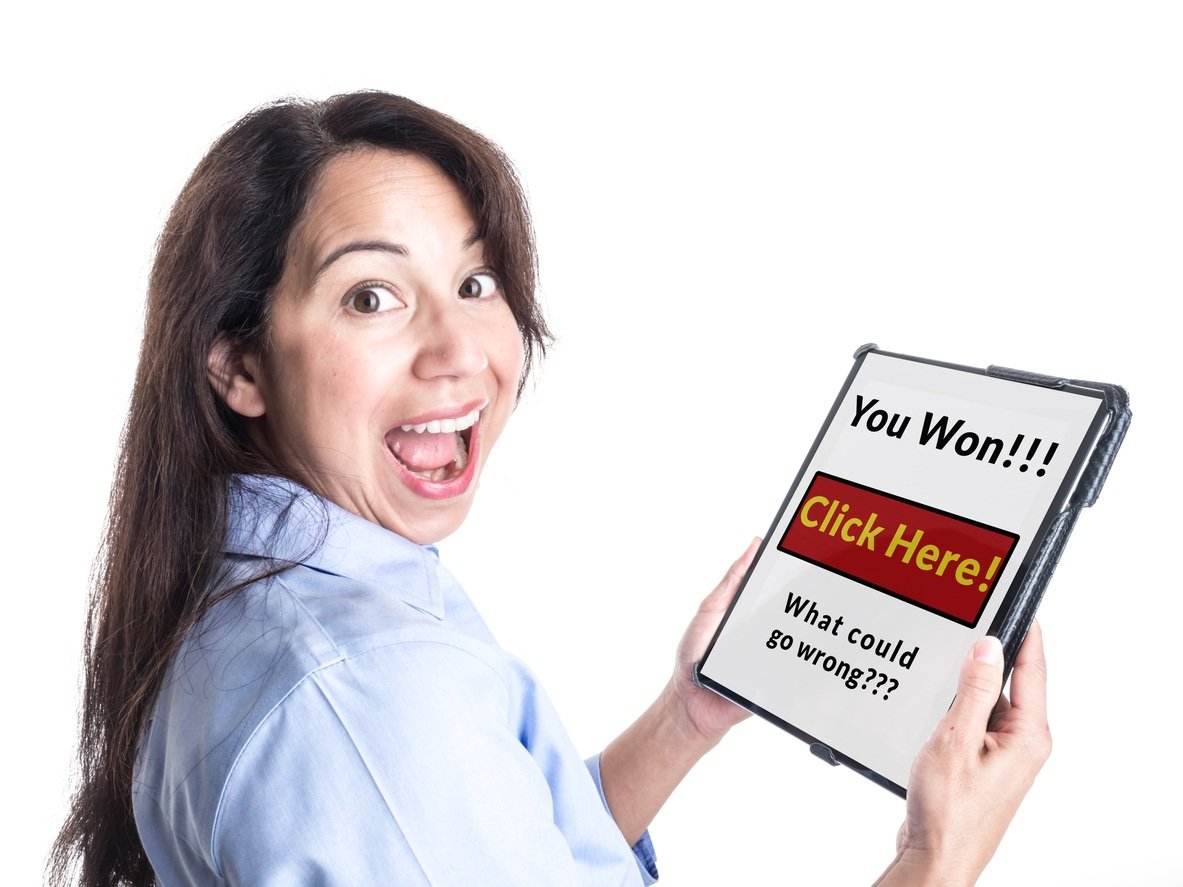 smiling woman holding a tablet that says "You won!!! Click here! What could go wrong???"