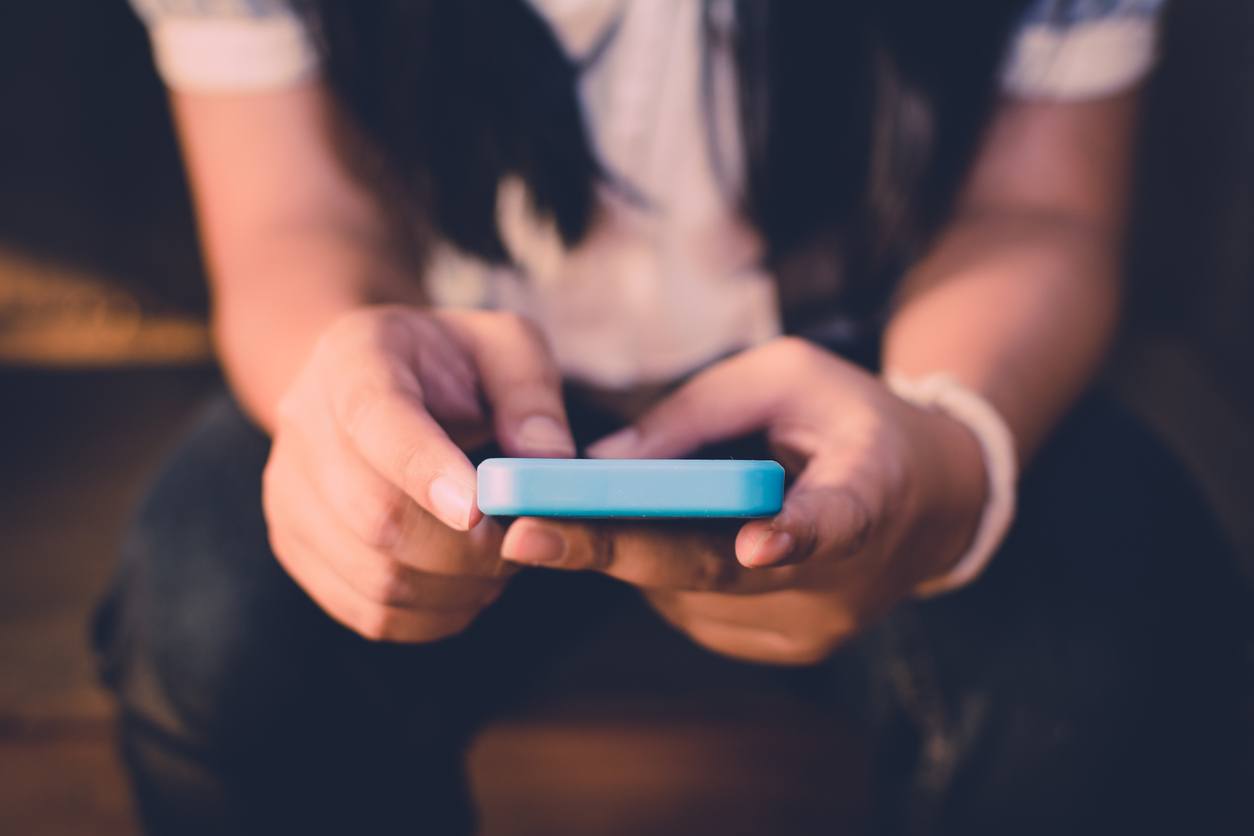 Woman sitting at a table using mobile phone