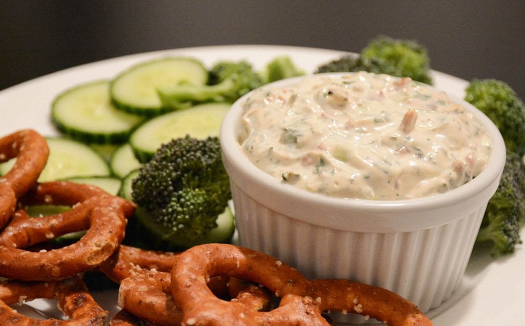 bacon and charred scallion dip served in a ramekin with veggies
