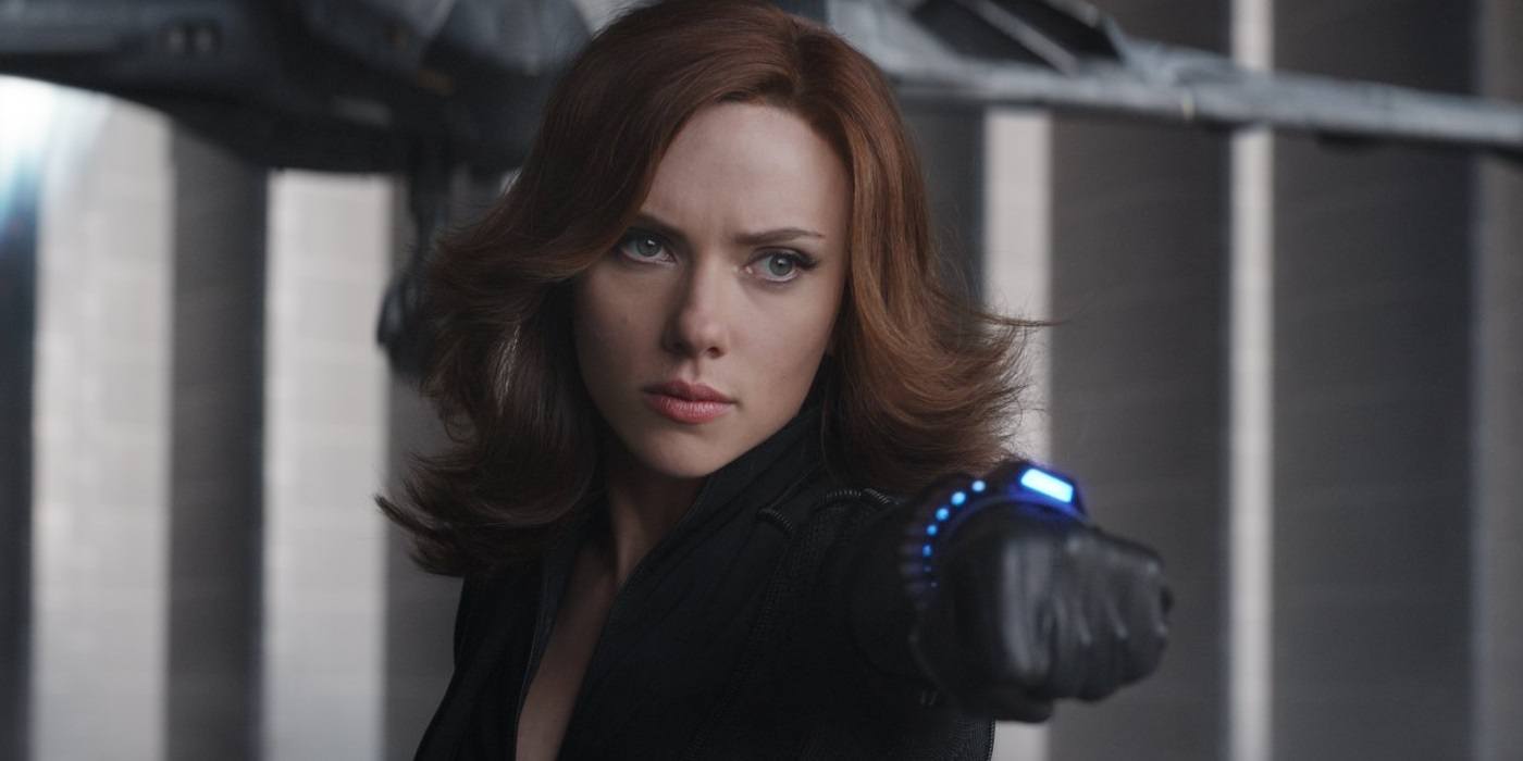 Scarlett Johansson as Black Widow holding out her fist