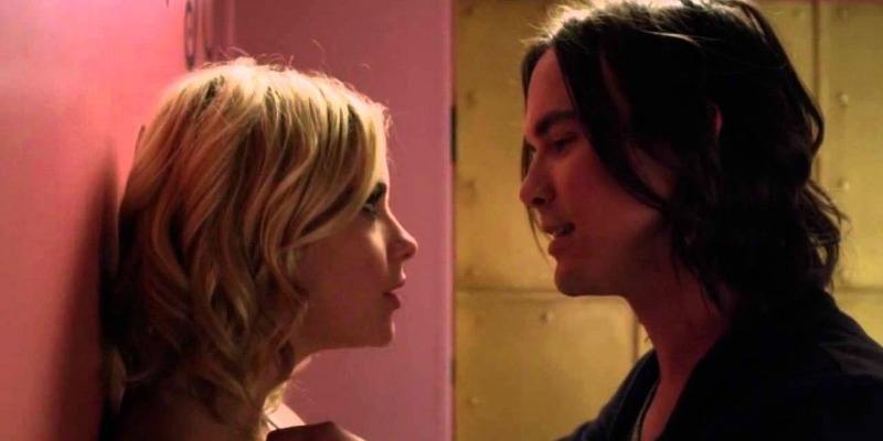 Hannah's back is against a wall and Caleb is talking very closely to her in.