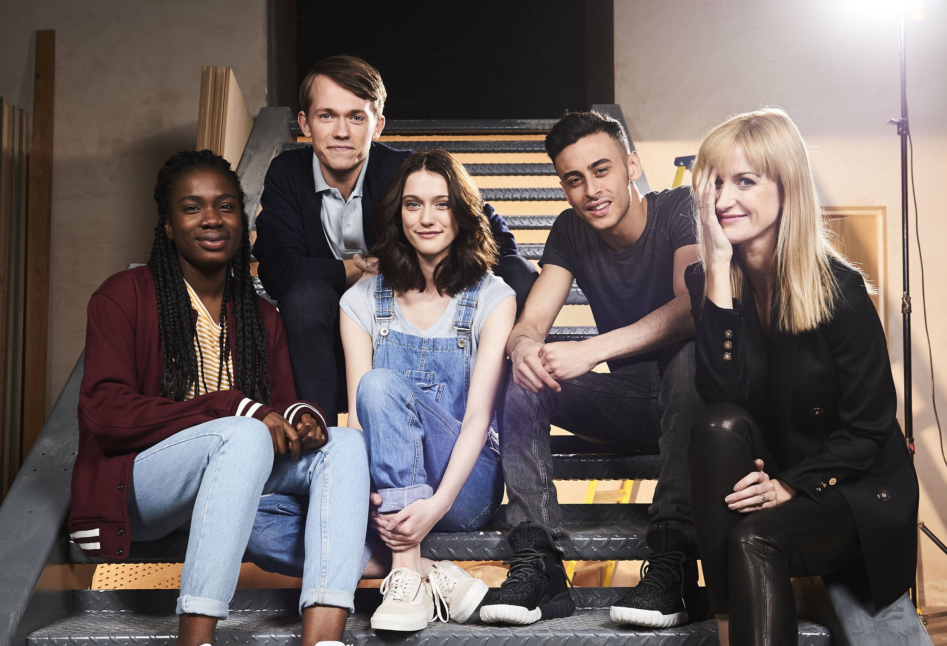 A group of people sit on stairs A group of people sit on stairs