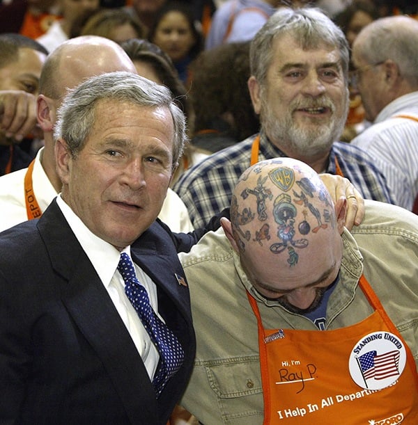 George W. Bush posing with a guy who has head tattoos