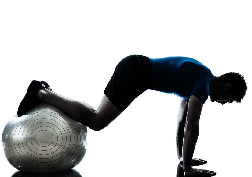 Man exercising with a stability ball