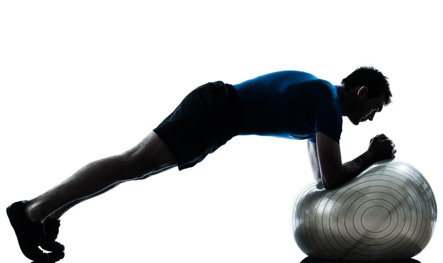 Man exercising with a stability ball