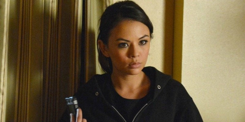 Mona is wearing a black hoodie and is looking very serious in Pretty Little Liars.