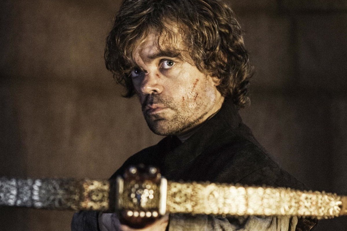 Tyrion aims a crossbow, looking directly into the camera
