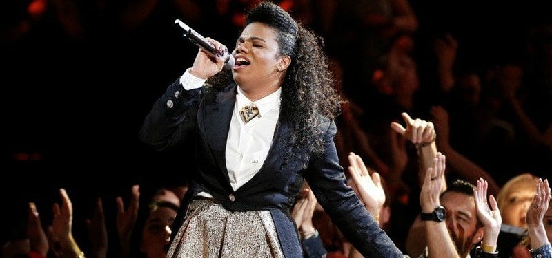A singer performs while the audience cheers. A singer performs while the audience cheers.