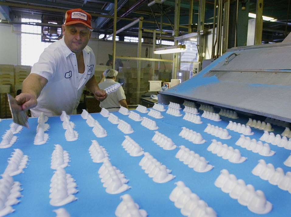 A worker inspects the marshmallow forms before they are coated with sugar at Just Born Inc. A worker inspects the marshmallow forms before they are coated with sugar at Just Born Inc.